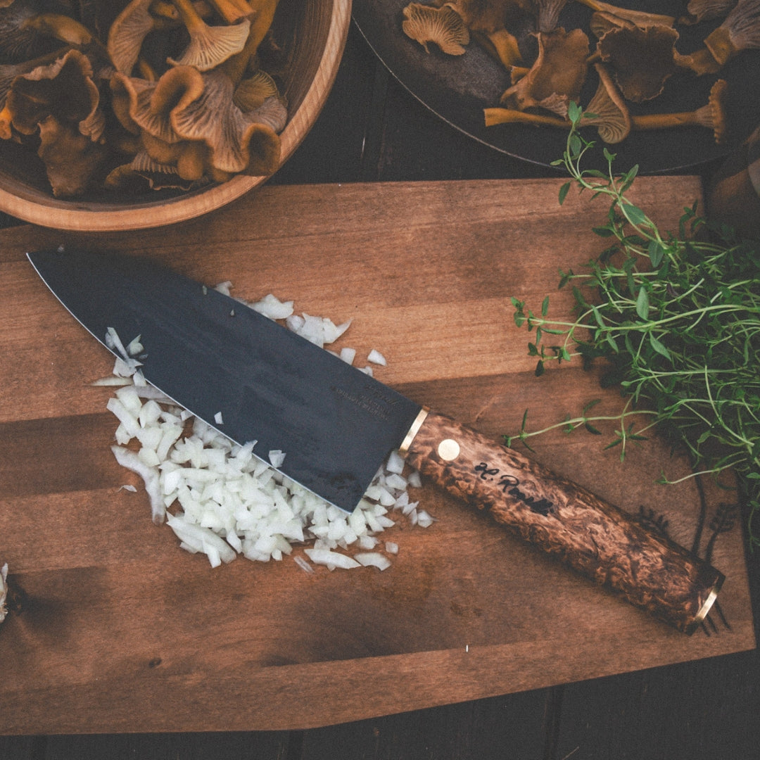 Roselli's Finnish handmade Japanese kitchen knife in model "Santoku knife". Made from carbon steel and curly birch. Comes with a handmade sheath of light vegetable Finnish leather. 